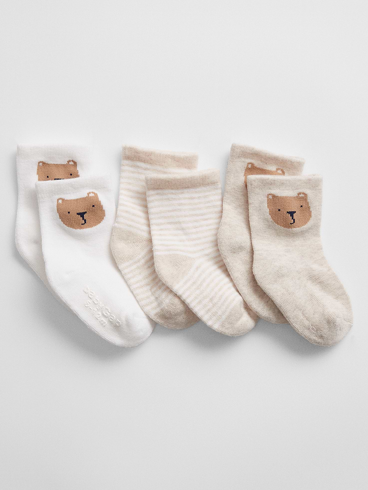 Image 1 of 1, Supersoft and cozy baby essentials featuring our signature Brannan Bear., Soft stretch knit., Ribbing at top., Reinforced toe and heel., Gripper logo at sole helps provide traction., Select styles have allover stripes, or Brannan Bear graphic., This product was made in a factory that invests in gender equity and women’s empowerment through RISE. Learn more at, Product #517044