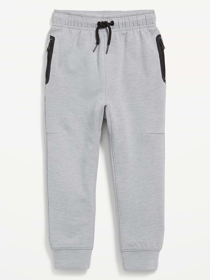 Image 1 of 1, Keep ‘em moving in Old Navy Sport's Dynamic Fleece: A soft, breathable cotton blend that's made to move., elasticized waistband, interior drawstring, vertical zippered pockets, banded cuffs, Product #490929