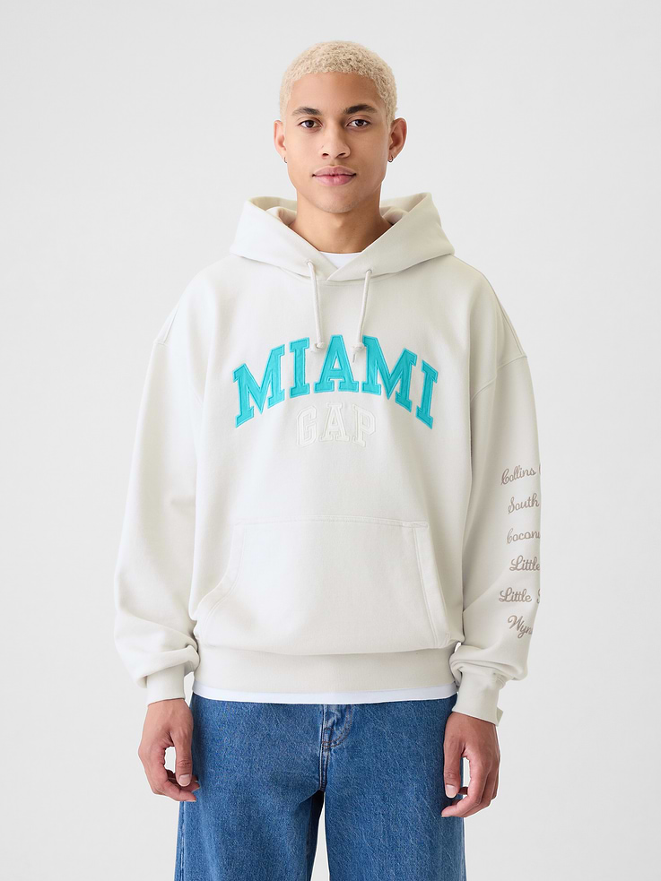 Image 1 of 5, Soft cotton-blend pullover colorblock hoodie., Hooded neckline with drawcords., Long sleeves., Front kanga pocket., Banded hem., Gap Miami logo at front, embroidered details at sleeve, city details and graphics at back., This hoodie is made with 14% recycled polyester. Compared to virgin materials, using recycled materials helps to reduce resource use and waste., This product was made in a factory that invests in gender equality and women’s empowerment. Through RISE (Reimagining Industry to Support Equality) and Gap Inc.’s program P.A.C.E. (Personal Advancement & Career Enhancement), we support people who make our clothes to build the skills, knowledge, confidence, and resilience needed to advance in work and life. Learn more here ., Product #534181