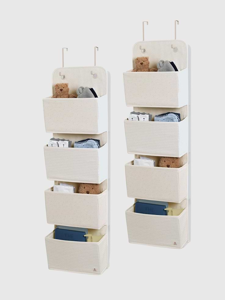 Image 1 of 3, This babyGap by Delta Children 2 Pack of Over the Door Storage Organizers is the perfect solution for organizing any nursery or child’s bedroom., The organizers feature an adorable polka dot motif, striped pattern and embroidered Brannan Bear for an elevated and uniquely babyGap look., Easy to hang and use, the organizers can be hung over the door with the provided universal hooks that work for most doors., Set of 2 organizers with 4 spacious pockets each provides plenty of storage space for diapers, clothing, toys, etc., Made of durable canvas. All 4 compartments have 3-sided support to keep the perfect shape when in use.