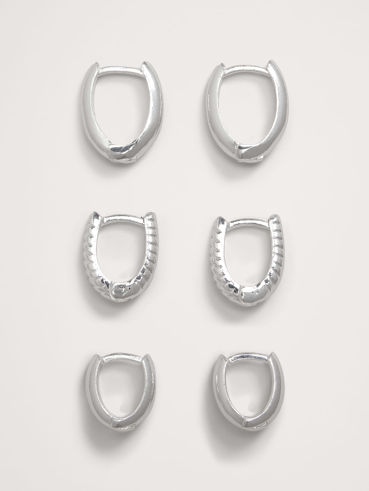 Ravena Oval Huggie Hoop Earrings Set Of 3 by Aureus + Argent