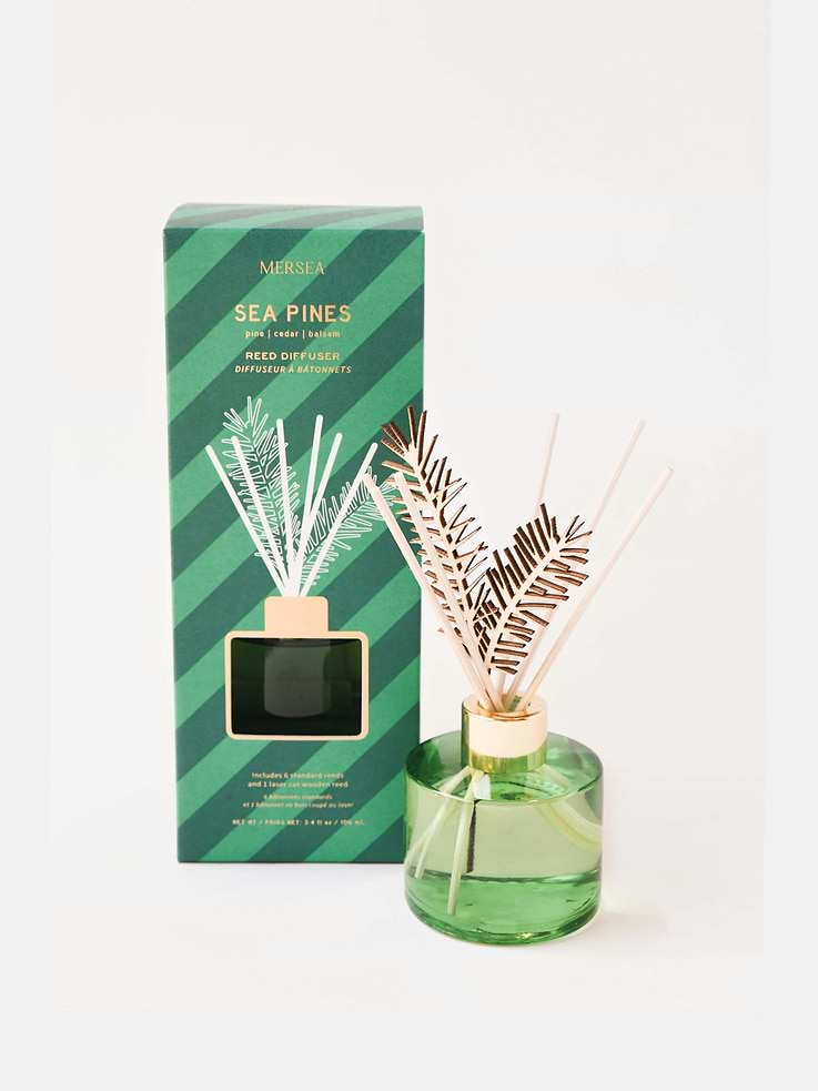 Image 1 of 1, Pine, Cedar, Balsam., The smell of pines never gets old, but cleaning up the mess they leave behind does., That’s why our Sea Pines scent is near and dear to our hearts and after so many years, still one of our best-selling scents., This fragrance has fresh pine and depth of cedar and balsam to fill your home with holiday spirit, hassle-free., Sea Pines knows how to keep the holidays as happy as can be., If you’re looking for a scent that lasts all season long and fills your space with a soothing and clean smell of fresh pines, this is your Reed Diffuser., With the holiday feeling and subtle green glass vessel, you’ll enjoy our quintessential Sea Pines fragrance in any room this piece sits., Bamboo reeds are mixed with three laser-cut reeds shaped as a pine sprig., Let the merriment begin!