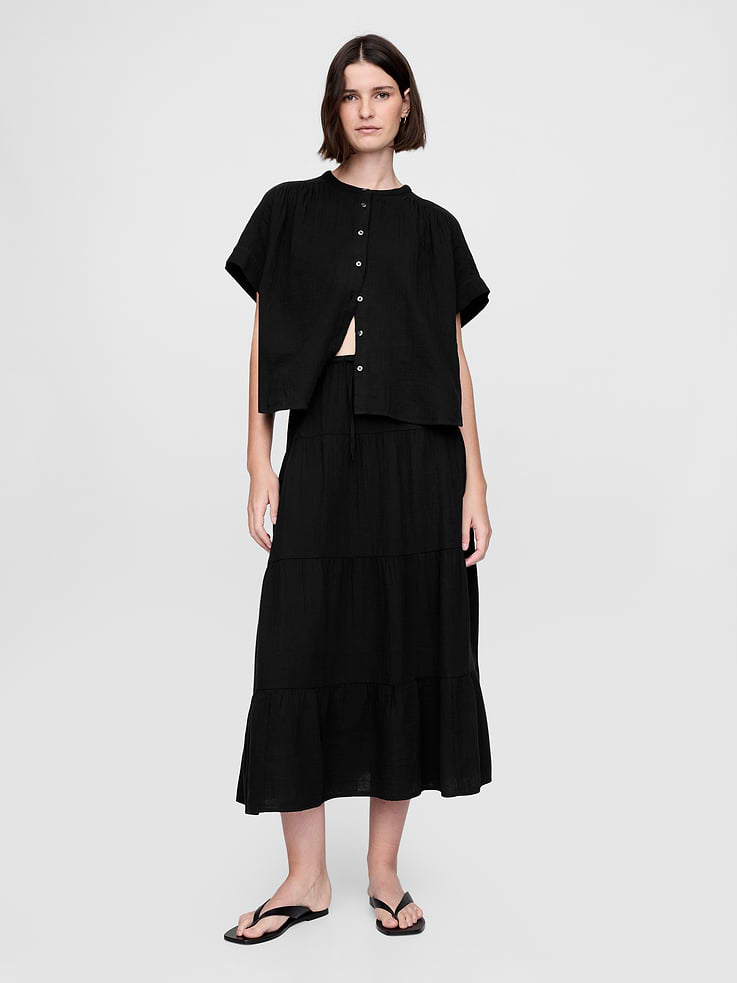 Image 1 of 5, A new summer essential, crafted in double-knit 100% cotton gauze. Soft and breathable. Light and airy. A signature — all season long., Soft cotton gauze maxi skirt., Elasticized waist with drawstring., Tiered hem., This product was made in a factory that invests in gender equality and women’s empowerment. Through RISE (Reimagining Industry to Support Equality) and Gap Inc.’s program P.A.C.E. (Personal Advancement & Career Enhancement), we support people who make our clothes to build the skills, knowledge, confidence, and resilience needed to advance in work and life. Learn more here ., Product #717436