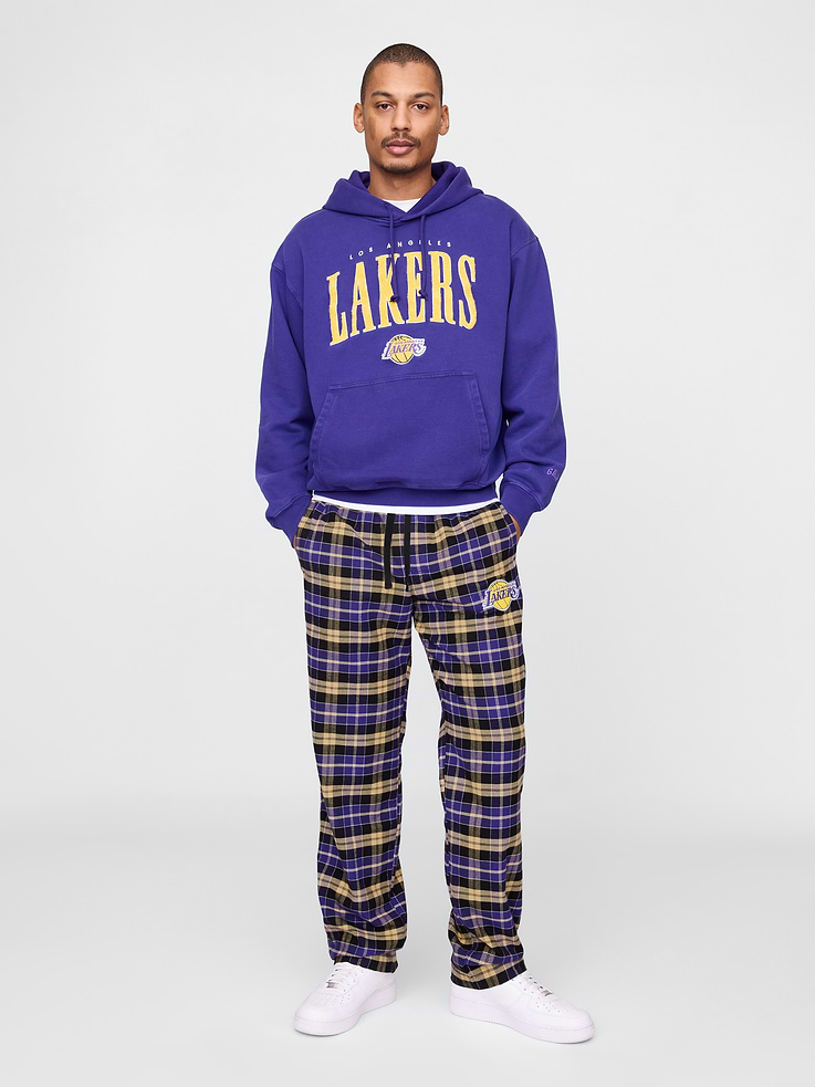 Image 1 of 7, We teamed up with the NBA to celebrate the league’s 75+ year history. Pairing iconic team logos with Gap classics. Made to celebrate the game, for the people who love it most., Soft cotton flannel pajama pants., Elasticized waist with drawcords., Front slant pockets., Los Angeles Lakers logo at thigh., Product #774010