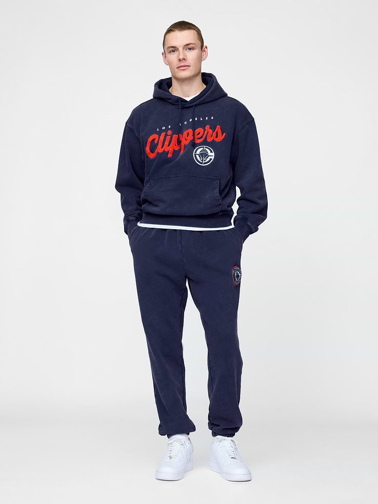Image 1 of 6, We teamed up with the NBA to celebrate the league’s 75+ year history. Pairing iconic team logos with Gap classics. Made to celebrate the game, for the people who love it most., Soft heavyweight cotton-blend joggers., Elasticized waist., Front slant pockets., Los Angeles Clippers logo at thigh., Elasticized hems., This style has a specialized mineral wash, which provides a vintage, lived-in look., Made with 14% recycled polyester. Compared to virgin materials, using recycled materials helps reduce resource use and waste., Product #765388