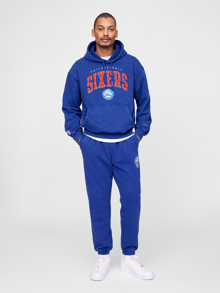Image 1 of 6, We teamed up with the NBA to celebrate the league’s 75+ year history. Pairing iconic team logos with Gap classics. Made to celebrate the game, for the people who love it most., Soft heavyweight cotton-blend joggers., Elasticized waist., Front slant pockets., Philadelphia Sixers logo at thigh., Elasticized hems., This style has a specialized mineral wash, which provides a vintage, lived-in look., Made with 14% recycled polyester. Compared to virgin materials, using recycled materials helps reduce resource use and waste., Product #765366