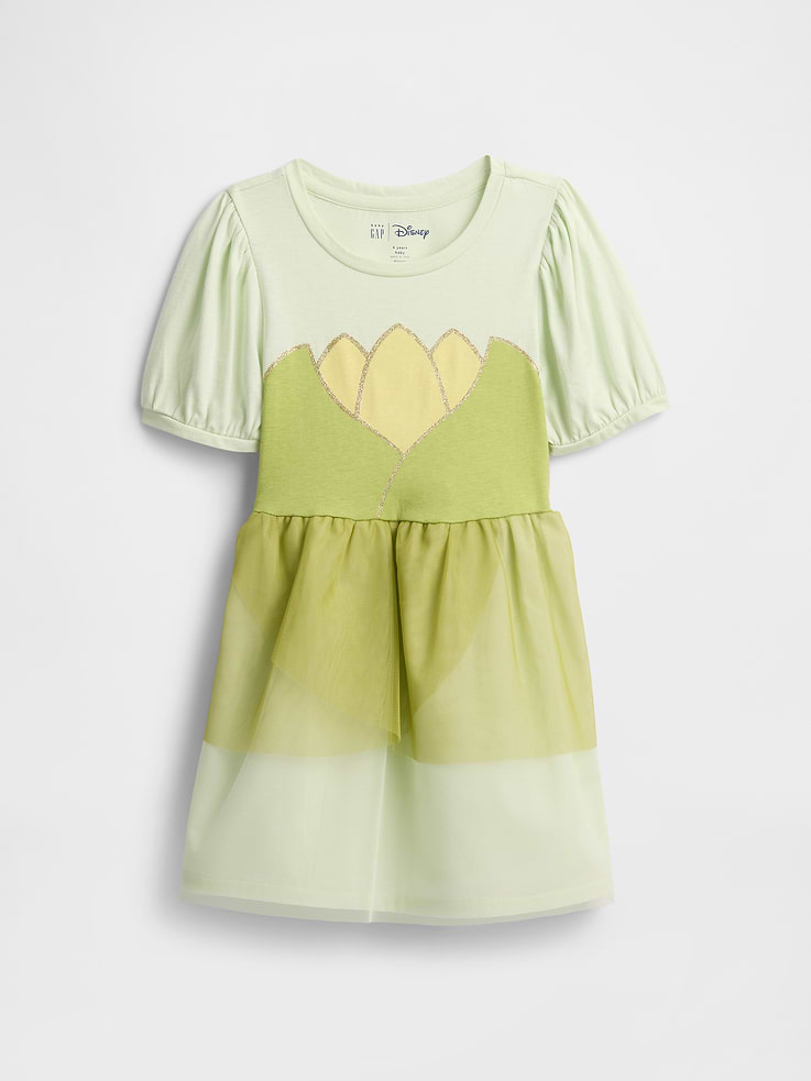 Image 1 of 3, A very special collaboration between Gap and Disney— two timeless, iconic American brands— led us to create a collection that celebrates Mickey Mouse and Minnie Mouse., Soft jersey top, smooth tulle skirt., Short puff sleeves with banded cuffs., Round neckline (sizes 6M-12M have keyhole with button closure at back)., Minnie Mouse graphics at front., Shirring at waist., Allover polka dots at skirt., This product was made in a factory that invests in gender equity and women’s empowerment through RISE. Learn more at, Product #532742