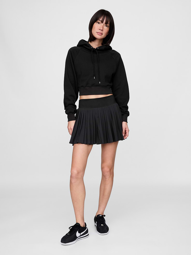 Image 1 of 5, Soft, breathable, quick-dry stretch woven pleated exercise skort., Wide elasticized waistband., Pleated skirt., Inner shorts., Curved hem., Moisture-wicking helps keep skin dry., This exercise skort is made with 86% recycled polyester. Compared to virgin materials, using recycled materials helps to reduce resource use and waste., This product was made in a factory that invests in gender equality and women’s empowerment. Through RISE (Reimagining Industry to Support Equality) and Gap Inc.’s program P.A.C.E. (Personal Advancement & Career Enhancement), we support people who make our clothes to build the skills, knowledge, confidence, and resilience needed to advance in work and life. Learn more here ., Product #771762