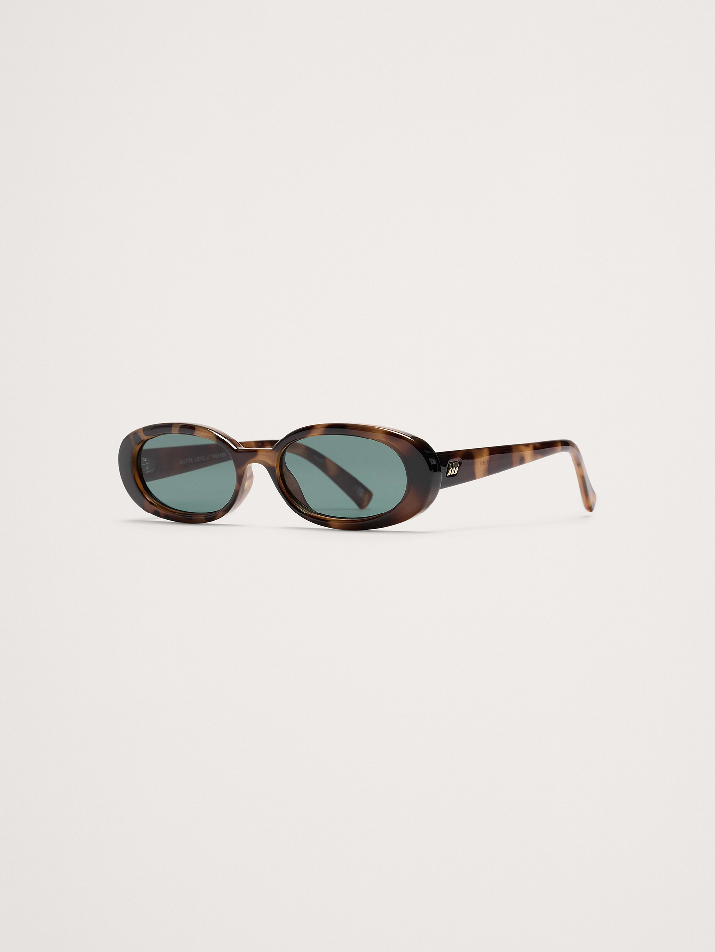 Image 1 of 1, Exuding '90s confidence, the iconic Outta Love silhouette offers a minimal look. This petite, slimline oval silhouette features a modern flat profile., Le Specs: Since 1979, Le Specs has become renowned globally for its iconic and innovative sunglass collections, developing an international cult following., Made using BPA free polymer plastic which is lightweight durable and impact resistant., Shatterproof and scratch resistant polycarbonate lenses.​, Includes protective pouch and microfiber cleaning cloth., Product #830747