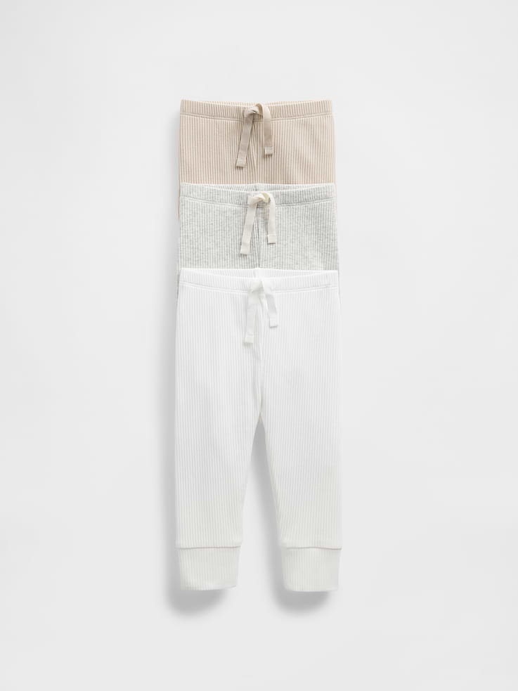 Image 1 of 2, From baby's first outfit to all their first moments. Our favorite essentials now in a teeny rib texture with supersize softness. With extra stretch for a little give as your little one grows., Supersoft tiny ribbed knit pull-on pants., Elasticized waist., Cuffs at leg openings., This product was made in a factory that invests in gender equality and women’s empowerment. Through RISE (Reimagining Industry to Support Equality) and Gap Inc.’s program P.A.C.E. (Personal Advancement & Career Enhancement), we support people who make our clothes to build the skills, knowledge, confidence, and resilience needed to advance in work and life. Learn more here ., Product #876780