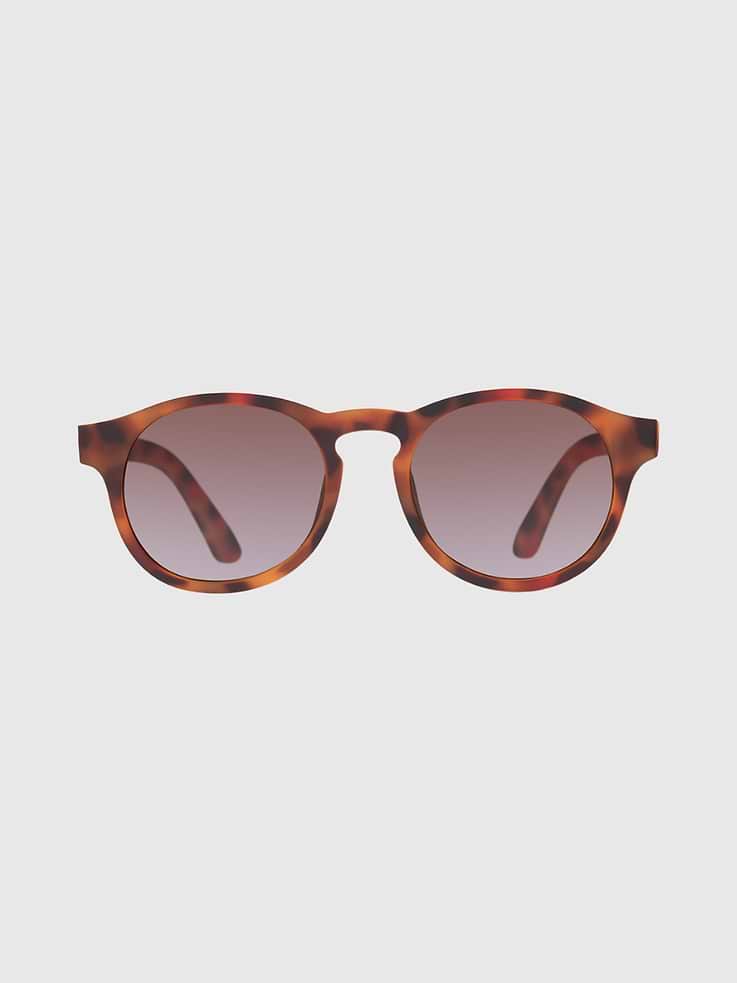 Image 1 of 3, An iconic round frame shape, these polarized Keyholes sunglasses are Babiatiors classic style., Featuring amber-colored, gradated lenses, these sun-safe shades won’t ever go out of style., Babiators sunglasses are highly durable, featuring flexible rubber frames and impact and shatter resistant lenses that won’t break when you bend, twist, or step on them., Each pair comes with a microfiber storage bag that doubles as a cleaning cloth to keep your little one’s shades safe and clean.