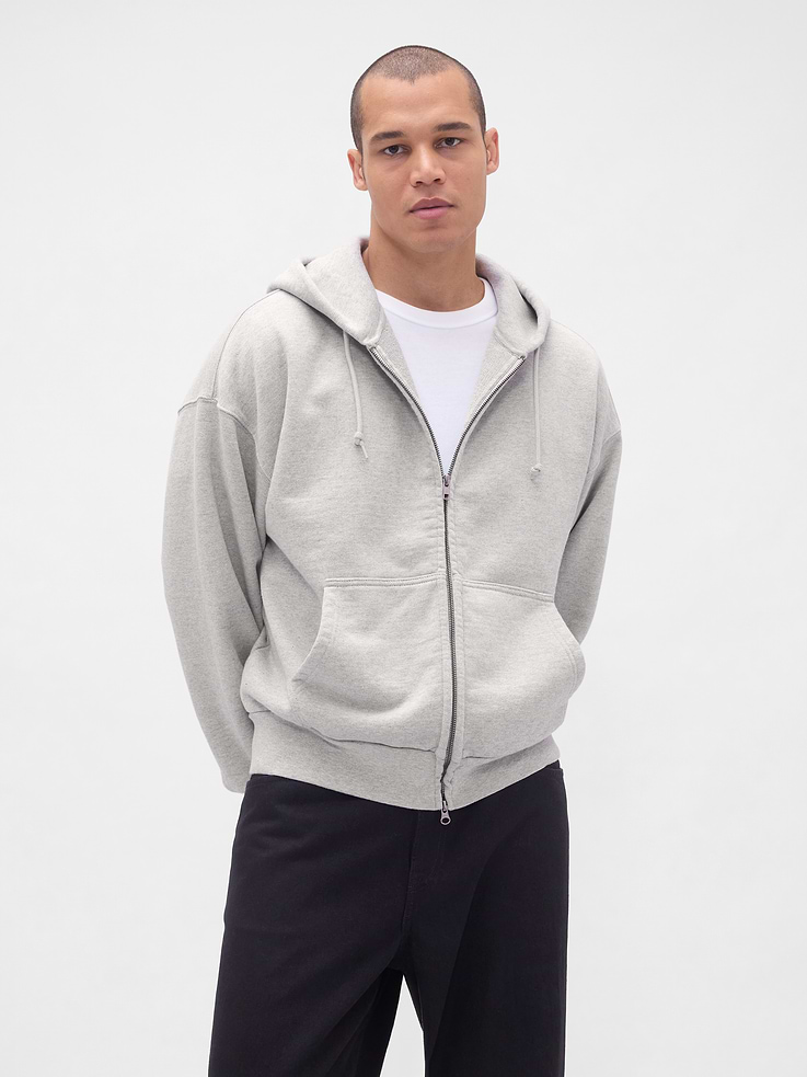 Image 1 of 8, Our newest, most premium hoodie to date. Nearly triple the weight of our standard fleece. Crafted with a thick, specially sourced yarn that holds up. Once you put it on, you get it., Soft, 650-gram heavyweight French terry hoodie. In an oversized fit., Hooded neckline with drawcords., Long sleeves., Two-way zipper front., Kanga pockets., Banded hem., Made with 18% recycled polyester. Compared to virgin materials, using recycled materials helps reduce resource use and waste., Explore our GapSweats Guide ., This product was made in a factory that invests in gender equity and women’s empowerment through RISE. Learn more at gapinc.com/equity., Product #821271