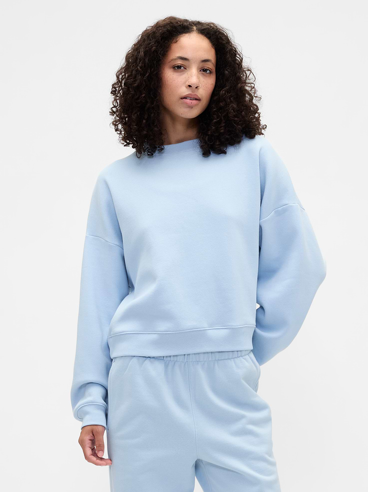 Image 1 of 5, This style is made with 23% recycled polyester. Compared to virgin materials, using recycled materials helps to reduce resource use and waste., Soft, comfy fleece., Dropped shoulder, long sleeves with banded cuffs., Crewneck., Banded wedge hem., Note: The dye used in the crafting of this product is prone to crocking, or color transfer. Please avoid contact with light-colored fabric or upholstery., This product was made in a factory that invests in gender equity and women’s empowerment through RISE. Learn more at, Product #734331