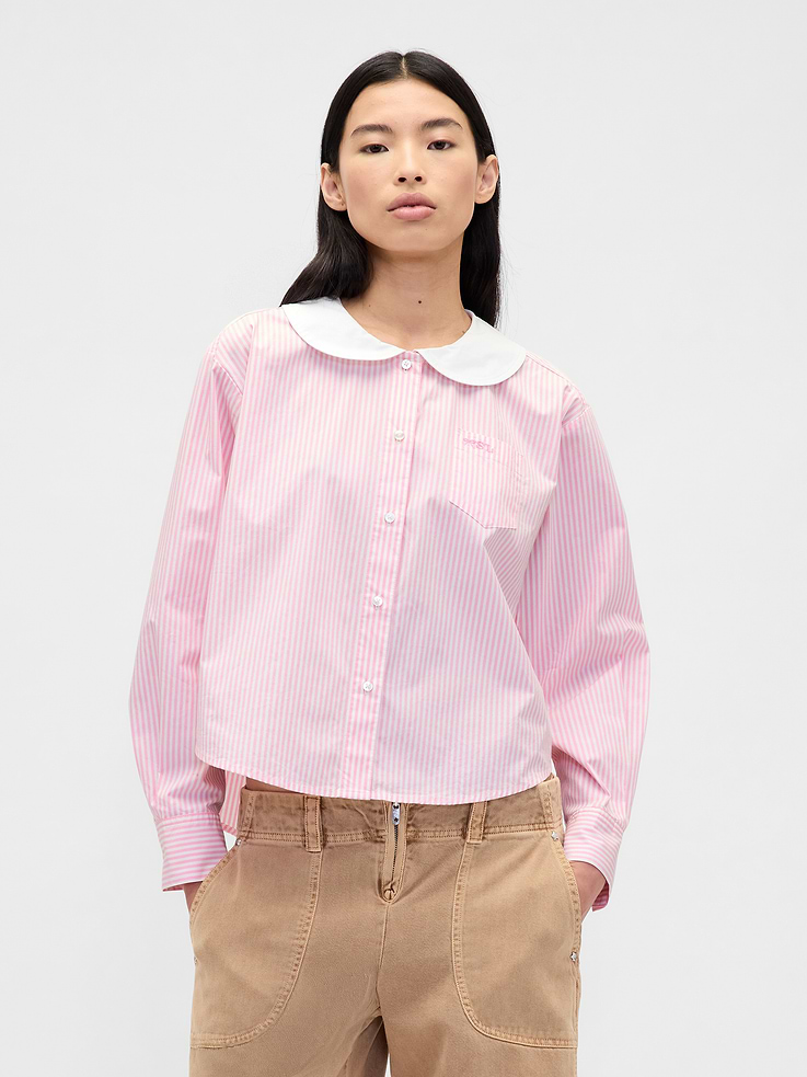 Image 1 of 2, Sandy Liang is designer born and raised in NYC. Inspired by nostalgia, she creates cult-favorite pieces influenced by childhood. Our collection draws from her memories of growing up with Gap. Archival hints. Playful details for adults. Elevated designs for kids. A celebration of modern girlhood only Gap × Sandy Liang could make., Soft, stretch cotton poplin shirt. In an extra-oversized, slightly cropped fit., Round collar, button front., Long sleeves with button cuffs., Embroidered patch pocket at chest., Allover stripes., Product #853521