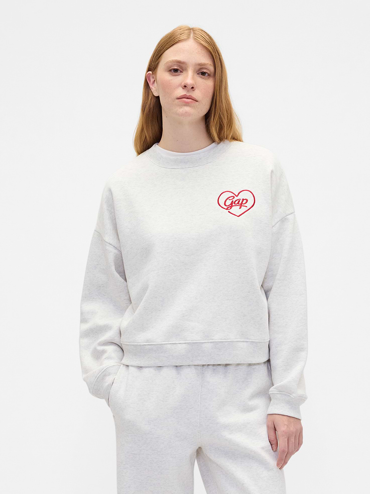 Image 1 of 5, This product is made with/contains 23% recycled polyester. Compared to virgin materials, using recycled materials helps reduce resource use and waste., Soft, comfy fleece., Dropped shoulder, long sleeves with banded cuffs., Crewneck., Assorted graphics at front., Banded wedge hem., This product was made in a factory that invests in gender equity and women’s empowerment through RISE. Learn more at, Product #844463