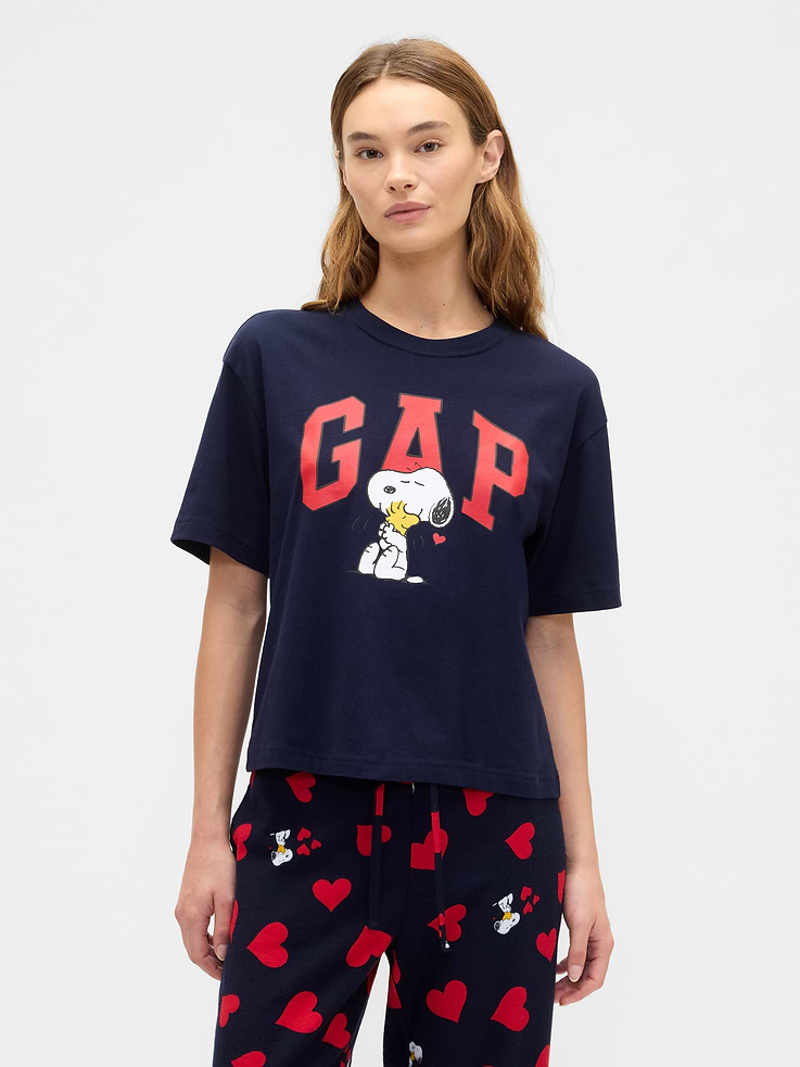 Image 1 of 5, Soft jersey knit., Dropped shoulder, elbow-length sleeves., Crewneck., Gap logo with Snoopy heart graphic at front., This product was made in a factory that invests in gender equity and women’s empowerment through RISE. Learn more at, Product #855135
