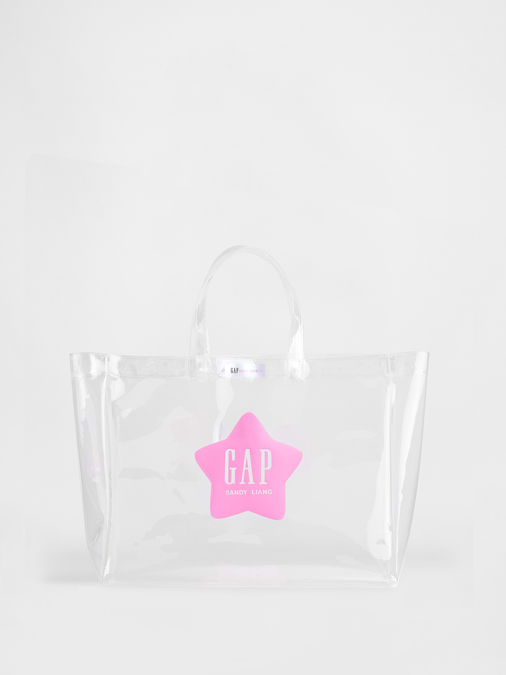 Image 1 of 2, Sandy Liang is designer born and raised in NYC. Inspired by nostalgia, she creates cult-favorite pieces influenced by childhood. Our collection draws from her memories of growing up with Gap. Archival hints. Playful details for adults. Elevated designs for kids. A celebration of modern girlhood only Gap × Sandy Liang could make., Sturdy, transparent tote bag., Handle at top., Gap × Sandy Liang logo in star graphic at front., Product #864523