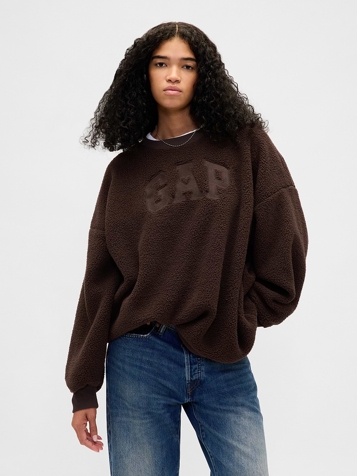 Image 1 of 5, Soft knit sherpa oversized sweatshirt. In a tunic length., Crewneck., Long sleeves with drop shoulders., Gap arch logo with heart at front., Banded cuffs & hem., Made with 70% recycled polyester. Compared to virgin materials, using recycled materials helps reduce resource use and waste., Explore our GapSweats Guide ., Product #844941