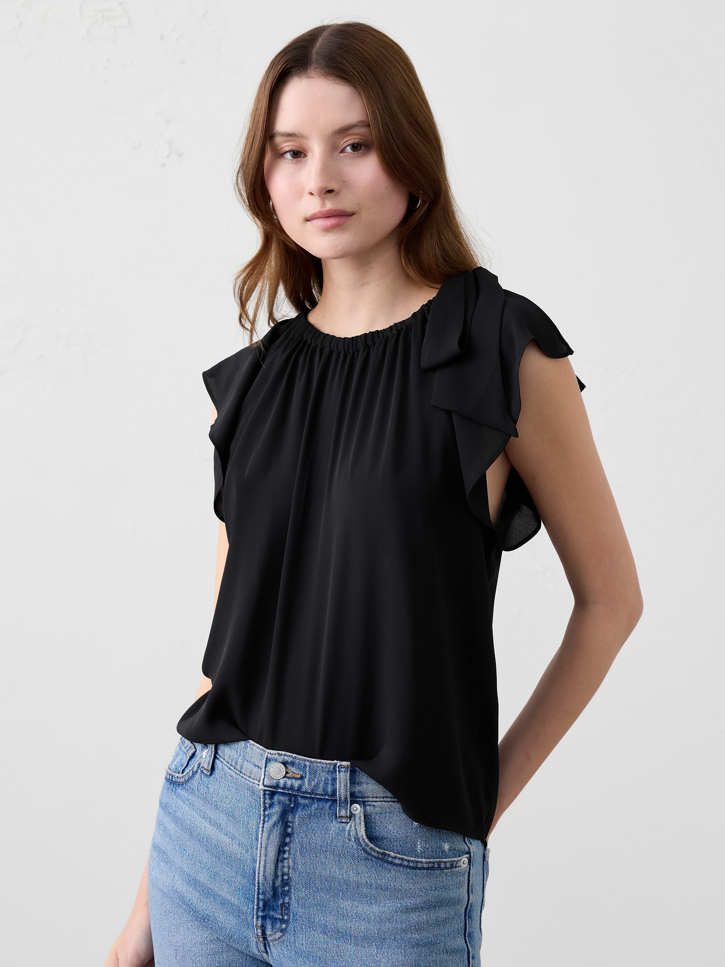 Image 1 of 1, Effortless elegance meets feminine charm in this airy top. Featuring a delicate shoulder tie and soft flutter sleeves, it drapes beautifully with gentle gathers along the neckline for a relaxed yet refined look., Crew neck. Cap sleeves., Features tied bow on wearer's left shoulder., Straight hem., Made exclusively for Banana Republic Factory., Product #844149