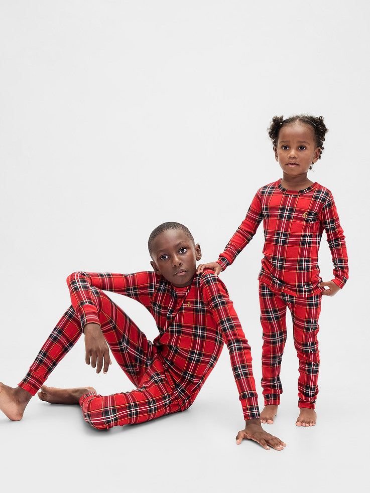 Image 1 of 7, Our comfiest PJs—now softer than ever. Cozy brushed cotton on the inside. All their favorite prints & colors on the outside., Soft cotton pajama top and pants set with a cozy brushed interior., Crewneck., Long sleeves., Embroidered Brannan Bear at chest., Elasticized waist at PJ pants., Banded cuffs., Assorted allover holiday prints., Made with 100% organically grown cotton, which is grown without the use of synthetic pesticides and fertilizers., Note: Sizing for select prints extends up to 12 YRS., Shop matching PJs for all., This product was made in a factory that invests in gender equity and women’s empowerment through RISE. Learn more at gapinc.com/equity., Product #844480