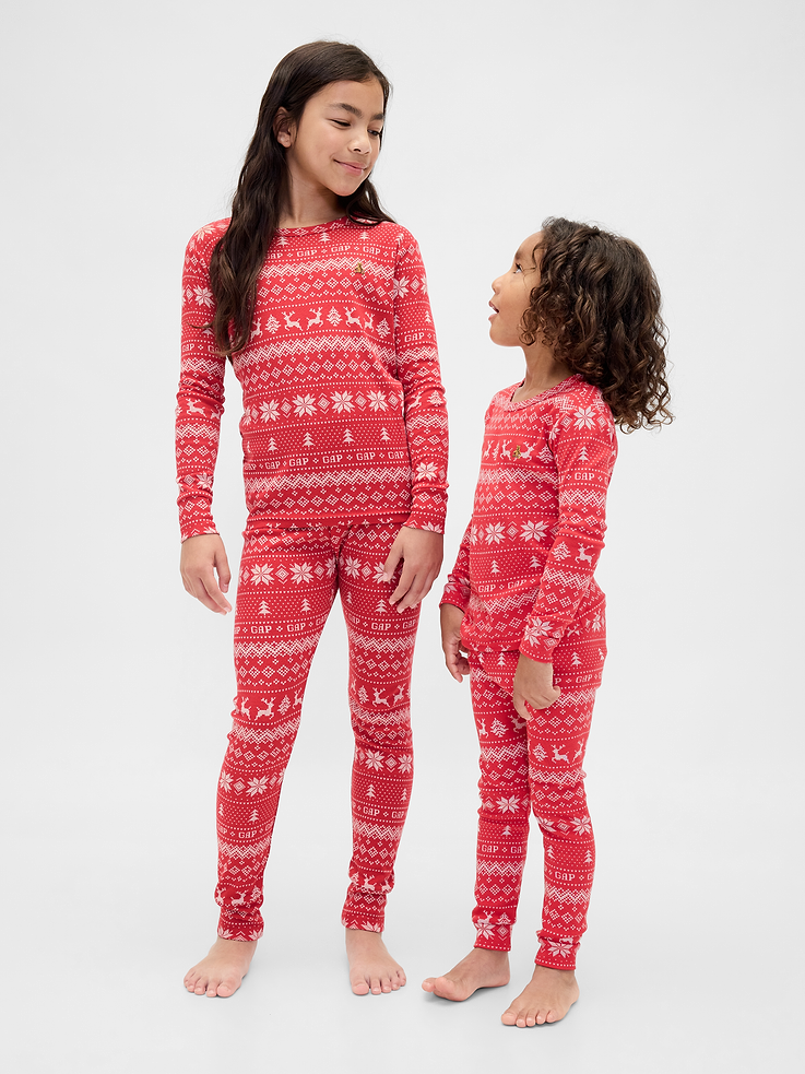 Image 1 of 7, Our comfiest PJs—now softer than ever. Cozy brushed cotton on the inside. All their favorite prints & colors on the outside., Soft cotton pajama top and pants set with a cozy brushed interior., Crewneck., Long sleeves., Embroidered Brannan Bear at chest., Elasticized waist at PJ pants., Banded cuffs., Assorted allover holiday prints., Made with 100% organically grown cotton, which is grown without the use of synthetic pesticides and fertilizers., Note: Sizing for select prints extends up to 12 YRS., Shop matching PJs for all., This product was made in a factory that invests in gender equity and women’s empowerment through RISE. Learn more at gapinc.com/equity., Product #844480