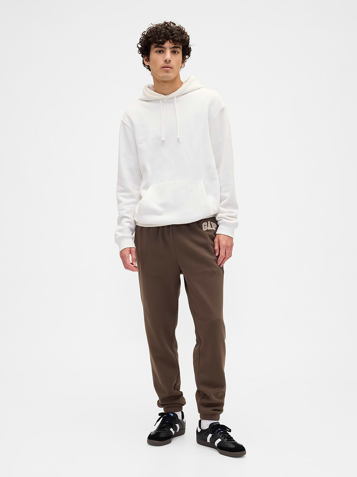 Image 1 of 4, Soft, comfy fleece., Drawcord ties at elasticized waistband., Gap logo at hip., On-seam pockets., Elasticized cuffs., This product was made in a factory that invests in gender equity and women’s empowerment through RISE. Learn more at, Product #659234