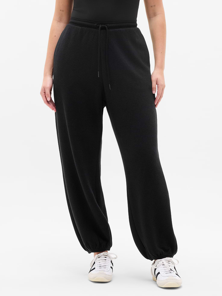 Image 1 of 6, FOR: Rest-day stretches and active recovery, FEEL: Ultra-soft waffle knit with all-way stretch, FAVE: Easy-access pockets, External drawcord for adjustability, Product #767985