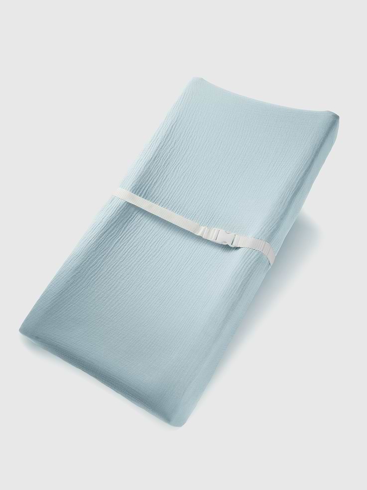 Image 1 of 5, This changing pad cover is made from breathable muslin cotton for softness and comfort., Its elastic edges ensure a snug fit on both flat and curved changing pads., Built-in openings support secure use with standard safety harness straps., Each piece is packaged in a gift box suitable for baby showers or new parents., Comfy Cubs designs baby essentials that prioritize softness, safety, and convenience.
