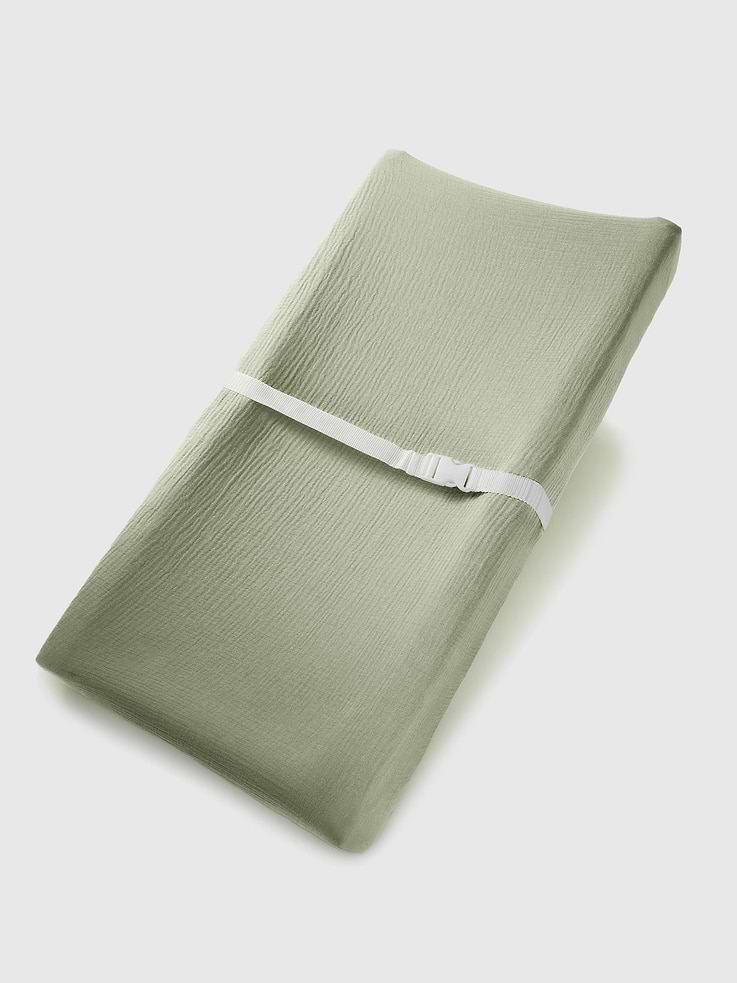 Image 1 of 5, This changing pad cover is made from breathable muslin cotton for softness and comfort., Its elastic edges ensure a snug fit on both flat and curved changing pads., Built-in openings support secure use with standard safety harness straps., Each piece is packaged in a gift box suitable for baby showers or new parents., Comfy Cubs designs baby essentials that prioritize softness, safety, and convenience.