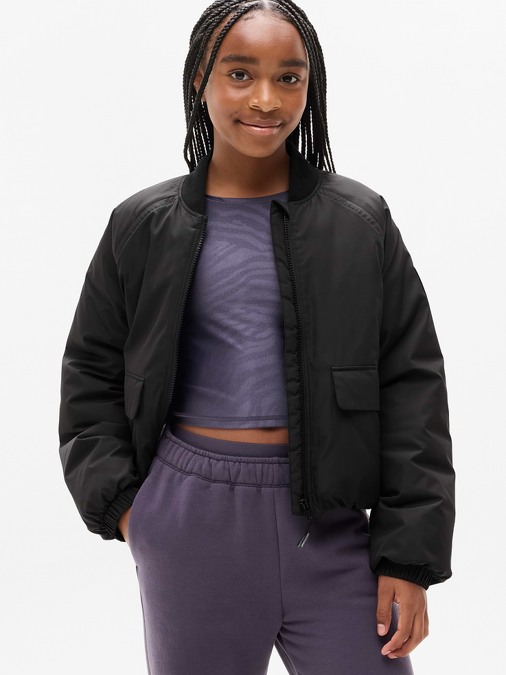 Image 1 of 5, Still stealing the show, even from the sidelines—introducing Simone Biles x Athleta., FOR: Inspiring confidence at school, practice, and other activities, FEEL: Lightweight insulation with a soft, sleek hand-feel, FAVE: Confidence charm in right pocket for fidgety fingers, Product #825860