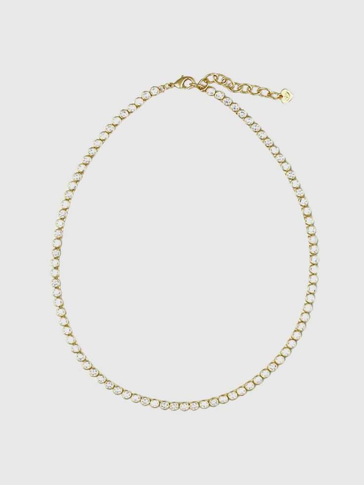 Image 1 of 4, Brilliant, but not too blingy., Most tennis necklaces don't come with an extender chain., Ours does, because we made it to easily mix into your necklace stack, so you can wear it high or low., Our simulated diamonds bring the striking look tennis necklaces are known for., Dress it down with a white tee, or pull out all the stops for your next glitzy night out., The Bezel Tennis Necklace features a type of gemstone setting that surrounds and holds the center stone using a continuous band of metal., HART is a boutique jewelry brand founded and run by women that believe outer sparkle ignites inner spark.