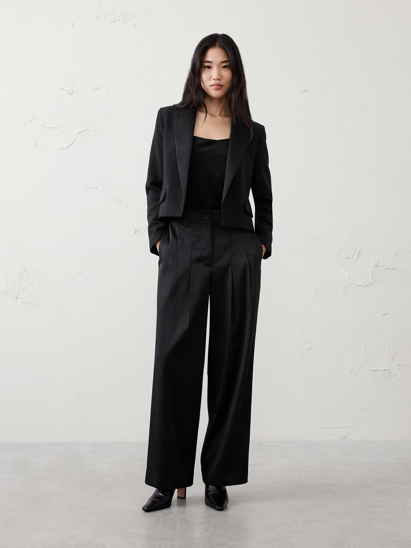 Image 1 of 1, Full length., Button closure with zip fly. Belt loops., Pleated front., On-seam side pockets., Buttoned welt back pockets., Back waist darts., Soft trouser crease., Made exclusively for Banana Republic Factory., Product #829970