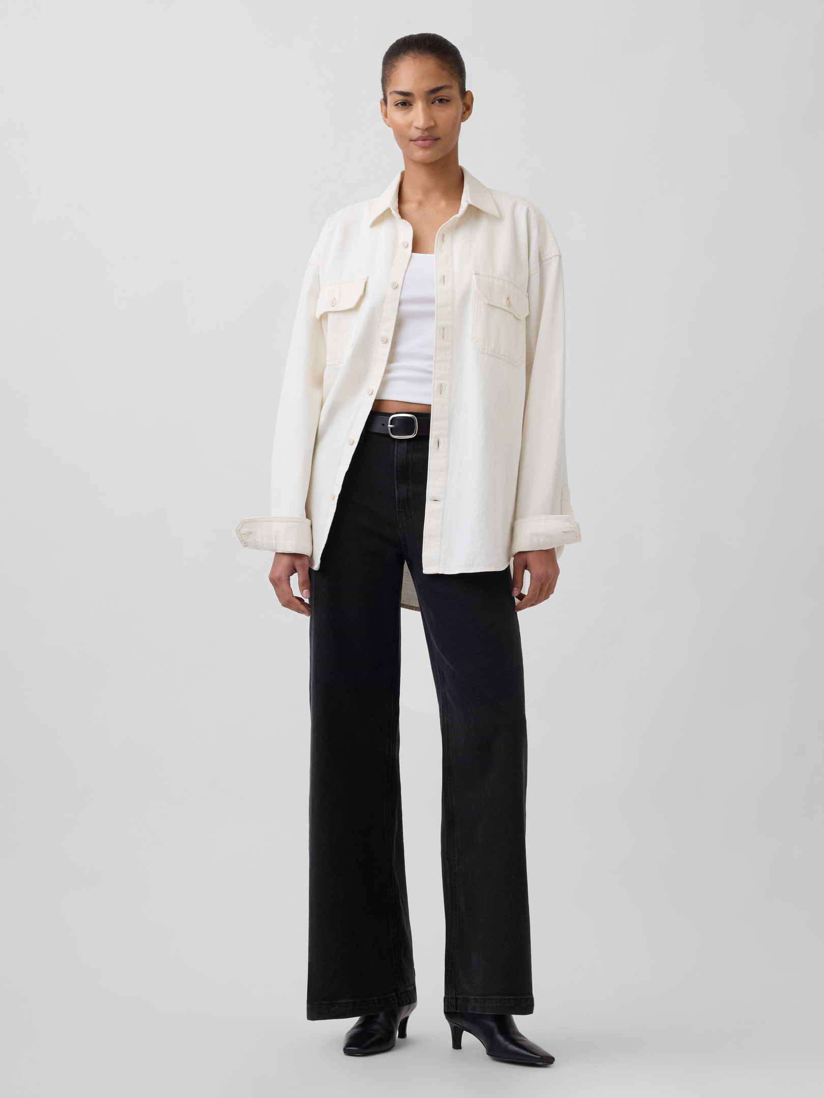 Image 1 of 9, Our born-to-chill wide-leg jean. A little give, a lot of easy & all kinds of pulled-together. If you need us, we'll be wearing these non-stop., Fit: Fitted in the waist & hips with a full-length, relaxed wide leg. This jean has a loose fit – size down for a slimmer fit., Fabric: 94% Cotton, 5% Recycled Materials, 1% Stretch., Stretch: Low Stretch Jeans. Our most comfortable authentic denim. Holds you in at the hips & waist but feels easy everywhere else., Rise: High Rise Jeans., Look: A classic five-pocket jean in a washed black wash., Details: Zip fly & five-pocket styling., Responsibly Made: This pair of jeans was made in a factory supported by our Gap Inc. P.A.C.E. program and is part of our water-saving Washwell program. Compared to conventional wash methods, Washwell has saved millions of liters of water since 2016.Our P.A.C.E program empowers women through career and life skill education for garment workers., Also available in Curvy ., This product was made in a factory that invests in gender equality and women’s empowerment. Through RISE (Reimagining Industry to Support Equality) and Gap Inc.’s program P.A.C.E. (Personal Advancement & Career Enhancement), we support people who make our clothes to build the skills, knowledge, confidence, and resilience needed to advance in work and life. Learn more here ., Product #406647