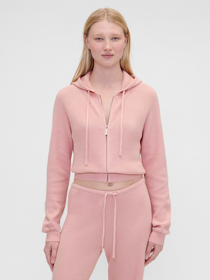 Image 1 of 6, Summer Fridays is a California beauty brand, known for its simplicity and ease. Made for the skin and the senses. We’ve partnered on this collection, bringing Summer Fridays together with Gap’s lounge essentials. Designed to unwind in. Crafted in our bestselling fabric that feels cashmere-soft.Crafted in a midweight plush yarn. Refined with a special brushed technique. It's everyday luxury., Supersoft waffle knit hoodie. In a cropped, relaxed fit., Hooded neckline with drawcords., Long sleeves., Logo zipper front., Logo coin detail at hem., Product #865196