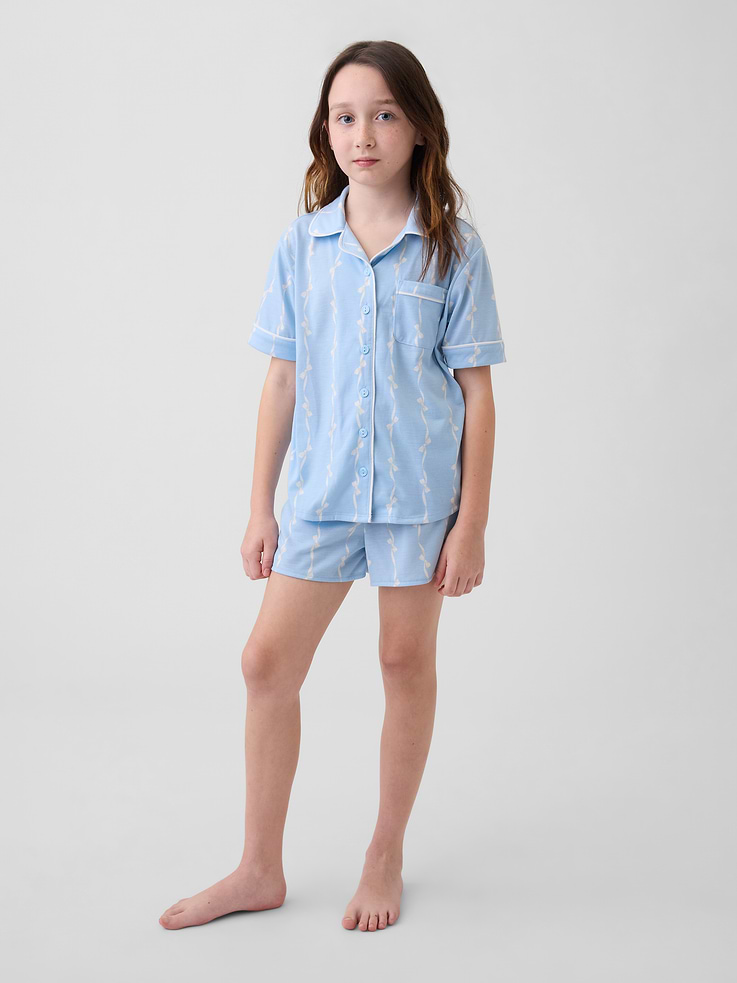 Image 1 of 4, Soft knit jersey pajama shirt and pajama shorts sleep set., Notch collar, button front., Short sleeves., Elasticized waist at PJ shorts., Chest patch pocket., Contrast binding., Elasticized waist at PJ shorts., Assorted allover prints., Made with 100% recycled polyester. Compared to virgin materials, using recycled materials helps reduce resource use and waste., This product was made in a factory that invests in gender equity and women’s empowerment through RISE. Learn more at gapinc.com/equity ., Product #884646