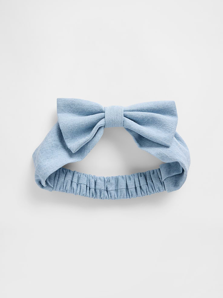 Image 1 of 1, Soft denim baby headband., Bow detail at front., Elasticized back., Medium wash., This product was made in a factory that invests in gender equity and women’s empowerment through RISE. Learn more at gapinc.com/equity ., Product #883661