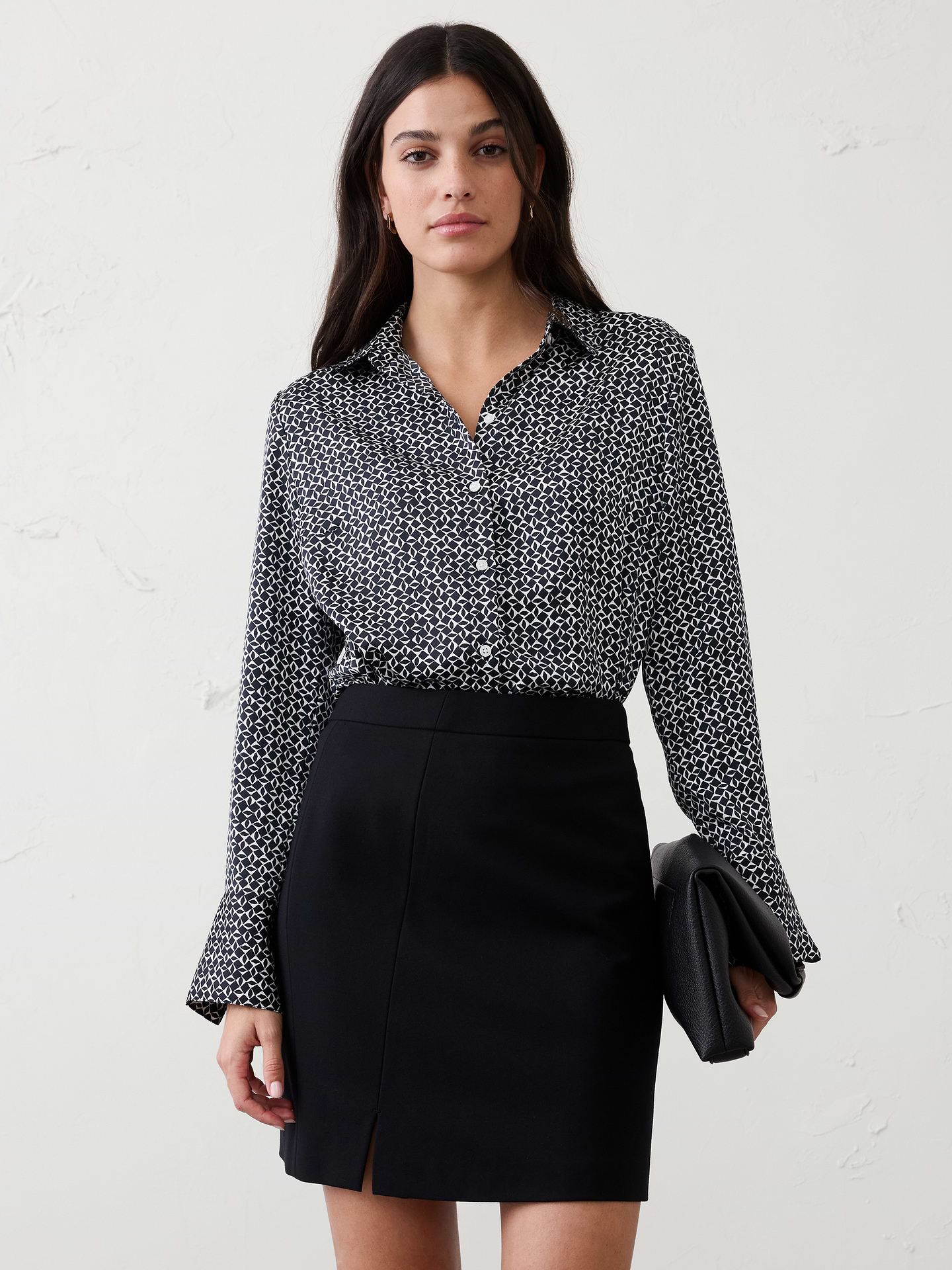 Image 1 of 8, Relaunch to our classic silky shirt in new recycled polyester fabric, silky crepe. More of a cleaner matte finish making this piece more elevated and modern., Point collar. Long sleeves with button cuffs., Button front closure., Back yoke with center box pleat., Shirttail hem., Made exclusively for Banana Republic Factory., Product #890602