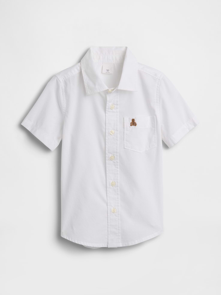 Image 1 of 3, Smooth poplin weave., Short sleeves., Spread collar, button front., Patch pocket with embroidered Brannan Bear at chest., Curved shirttail hem., Select styles have allover print., This product was made in a factory that invests in gender equity and women’s empowerment through RISE. Learn more at, Product #1172610