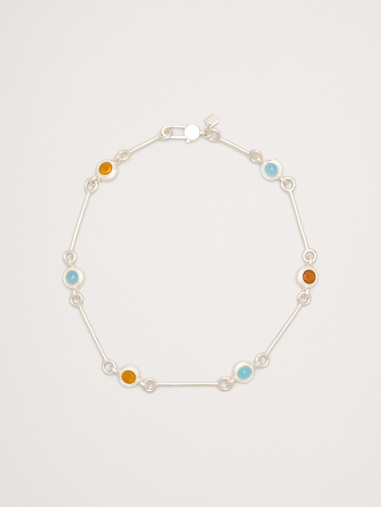 Image 1 of 3, A variety of long and short bar links intersect with shining gemstone accents, in your choice of 14k-gold or 999-silver plated brass., 14k-gold or 999-silver plated brass., Lobster clasp., Mango quartz and blue chalcedony stones., Product #894346