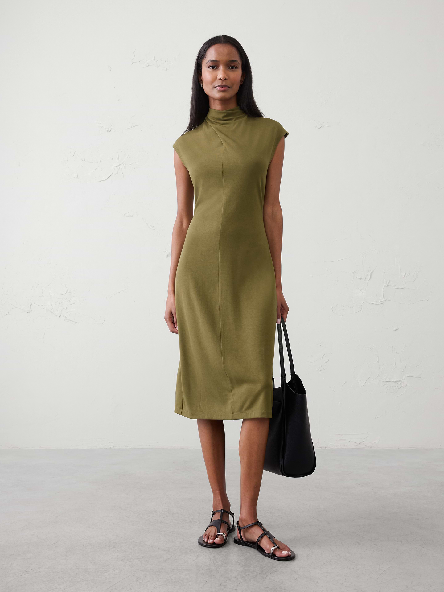 Image 1 of 4, SOFT INTERLOCK: Smooth, breathable, and irresistibly soft., Softly draped cowl‑inspired mock neckline. Sleeveless., Vertical seaming for subtle shaping., Straight hem with center‑back slit., Made exclusively for Banana Republic Factory., Product #1173398