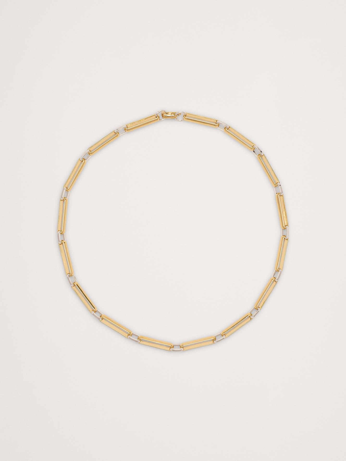 Image 1 of 3, Hand linked chain necklace constructed from elongated oval and flat wire links., Laura Lombardi: New York–based jewelry brand creating sculptural, minimalist pieces with an architectural edge, crafted with intention and designed to endure beyond trends., 14k-gold and rhodium plated brass., Foldover bar clasp., Product #895209