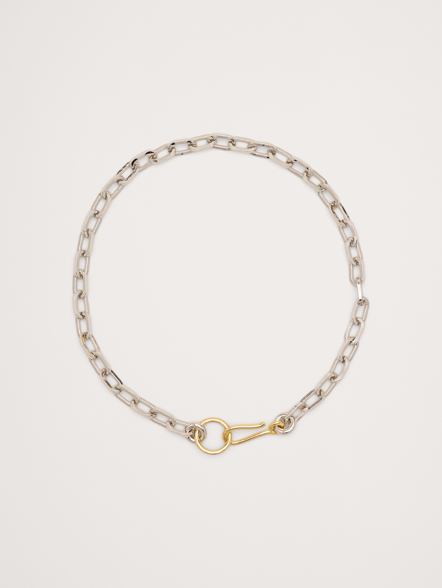 Image 1 of 3, Flat chain link necklace featuring an oversized hook and ring closure., Laura Lombardi: New York–based jewelry brand creating sculptural, minimalist pieces with an architectural edge, crafted with intention and designed to endure beyond trends., 14k-gold and rhodium plated brass., Hook and ring clasp., Product #895214