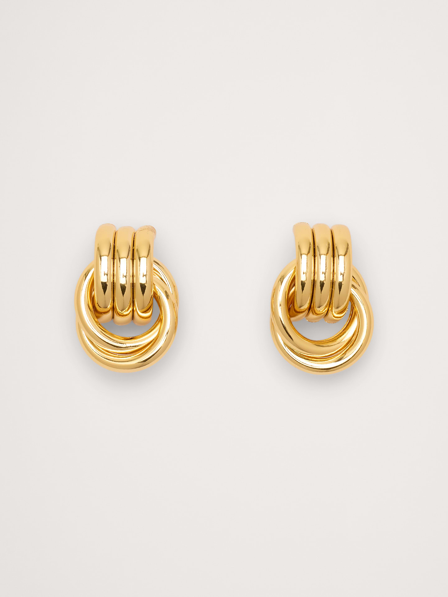 Image 1 of 4, Meet the Baby Knot Earrings — a sculptural statement in a smaller, wearable size. Designed with Heaven Mayhem’s signature twisted knot silhouette, these earrings deliver bold impact without the weight. Their hollow construction keeps them ultra-light, making them perfect for all-day wear, even for sensitive ears., Heaven Mayhem: Los Angeles–based accessories brand creating vintage‑inspired statement pieces reimagined for the modern wardrobe—timeless, sculptural designs made to elevate everyday style., 18k-gold or silver-plated stainless steel., Post backs., Product #899761