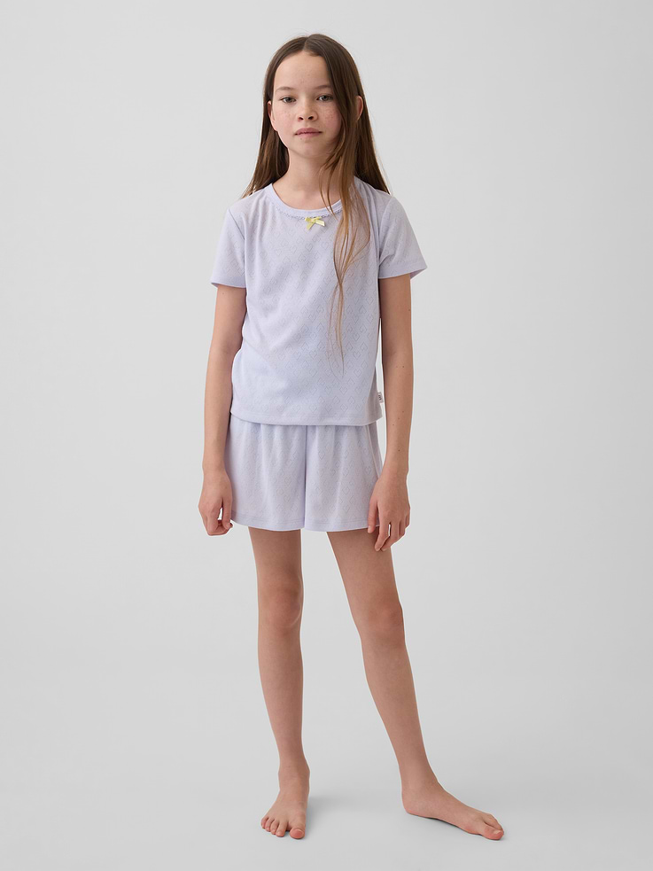 Image 1 of 4, Soft pointelle knit jersey pajama shorts. In a loose fit., Elasticized waist with satin bow at front., Certain styles have an allover print., Made with 100% recycled polyester. Compared to virgin materials, using recycled materials helps reduce resource use and waste., Note: Mix and match colors and prints to create your own PJ set., This product was made in a factory that invests in gender equity and women’s empowerment through RISE. Learn more at gapinc.com/equity ., Product #884637
