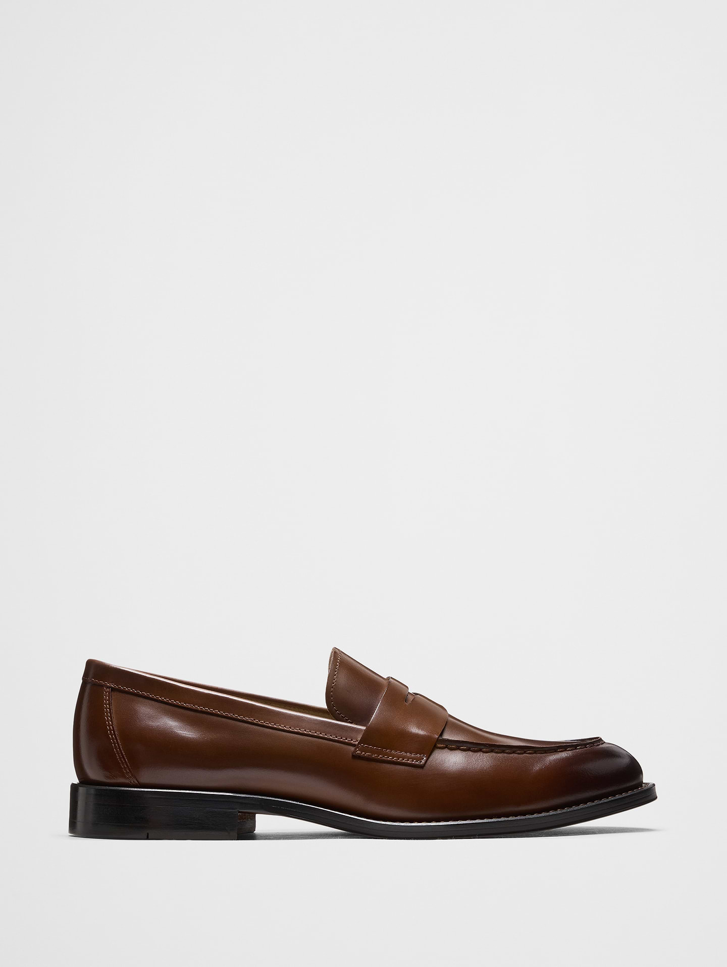 Image 1 of 5, Our leather penny loafer showcases a rich, burnished sheen that highlights its sculpted silhouette. Classic moc‑stitched detailing and a traditional penny keeper honor the heritage design, while the clean welt and streamlined sole bring a contemporary edge. Soft lining and a cushioned insole deliver all‑day comfort, making it an effortlessly elevated choice for both work and weekend., Made exclusively for Banana Republic Factory., Product #864729