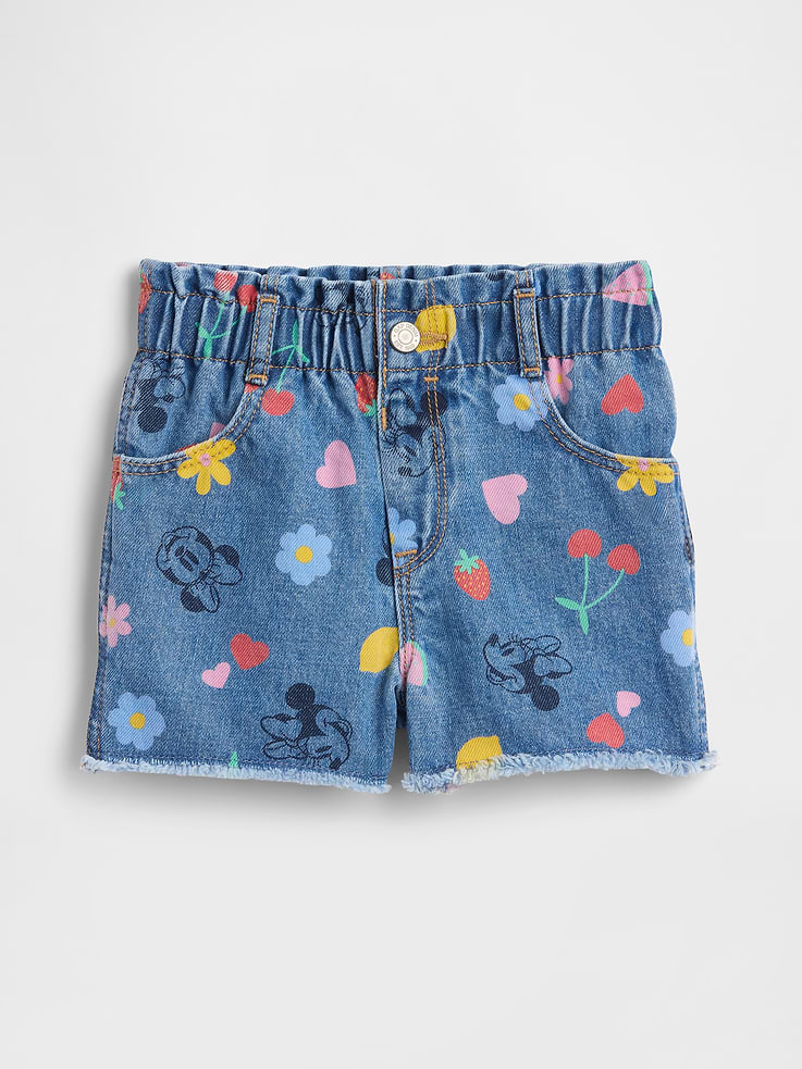 Image 1 of 3, A very special collaboration between Gap and Disney— two timeless, iconic American brands— led us to create a collection that celebrates Mickey Mouse and Minnie Mouse., This product is made with/contains 5% recycled cotton. Compared to virgin materials, using recycled materials helps reduce resource use and waste., This product is part of our water-saving Washwell program. Compared with conventional wash methods, Washwell uses at least 20% less water., Non-stretch denim., Medium indigo wash with fading., Elasticized paperbag waist., Snap closure, and now with easy faux fly for all sizes. Select inventory may temporarily include zip fly for sizes 2T-5T., Front slant pockets, patch pockets at back., Raw hems., Allover Minnie Mouse print., Product #1172335