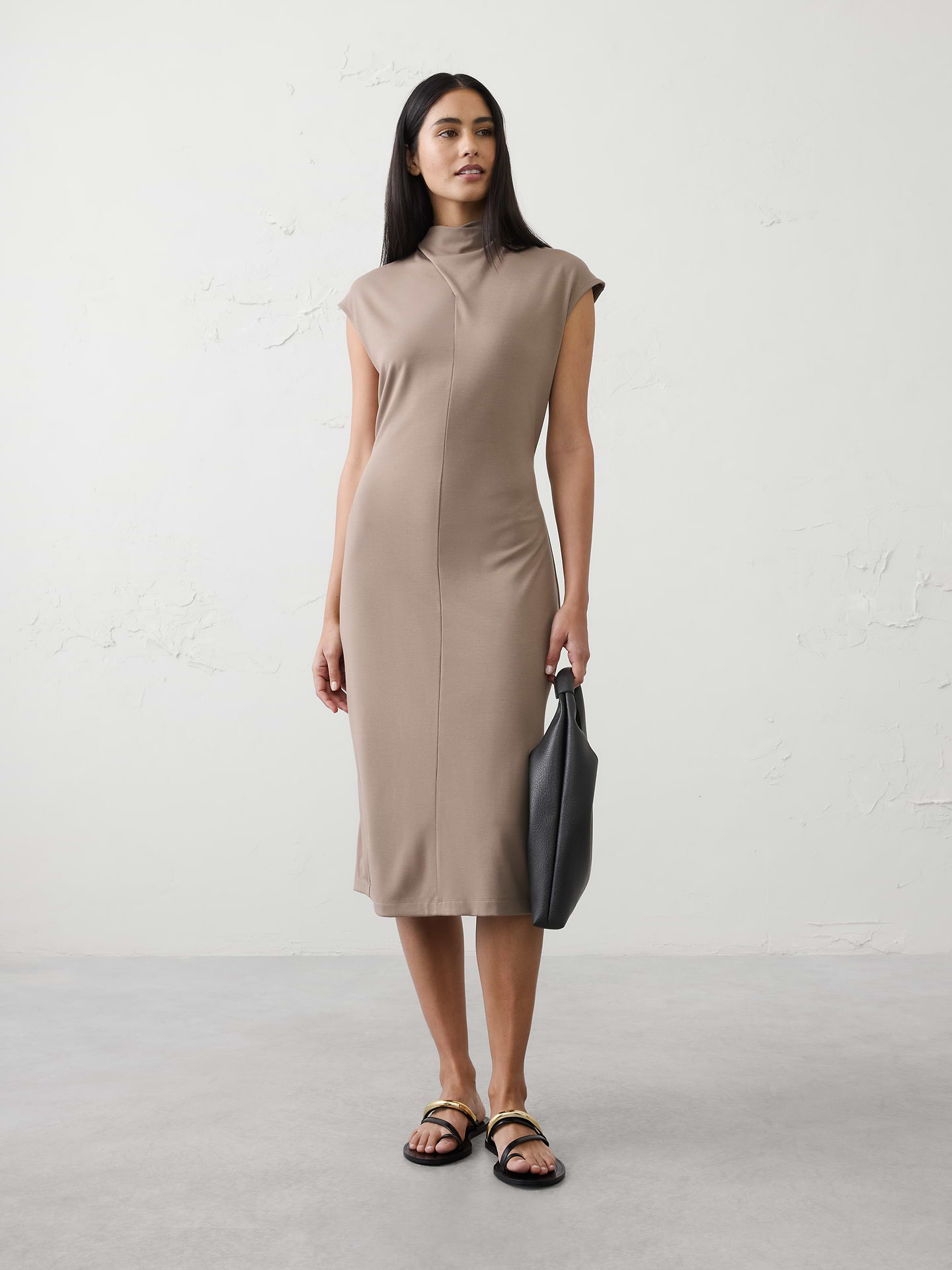 Image 1 of 4, SOFT INTERLOCK: Smooth, breathable, and irresistibly soft., Softly draped cowl‑inspired mock neckline. Sleeveless., Vertical seaming for subtle shaping., Straight hem with center‑back slit., Made exclusively for Banana Republic Factory., Product #1173398