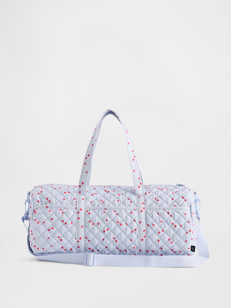 Image 1 of 3, This weekender bag is made with a quilted upper., Top handles., Adjustable shoulder strap. Certain styles have a pom detail at hook closure., Zipper closure., Pockets at front., Allover leopard or cherries print., Product #883722