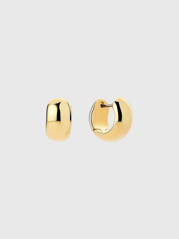 Image 1 of 2, Subtle yet statement-making, these gold huggie hoops are an elevated take on a timeless silhouette., Plated in 14K gold, these huggies feature a chunky design and a polished finish for added shine., Ana Luisa is a jewelry brand founded in 2018 to elevate everyday, with Earth-friendly jewelry that lasts.