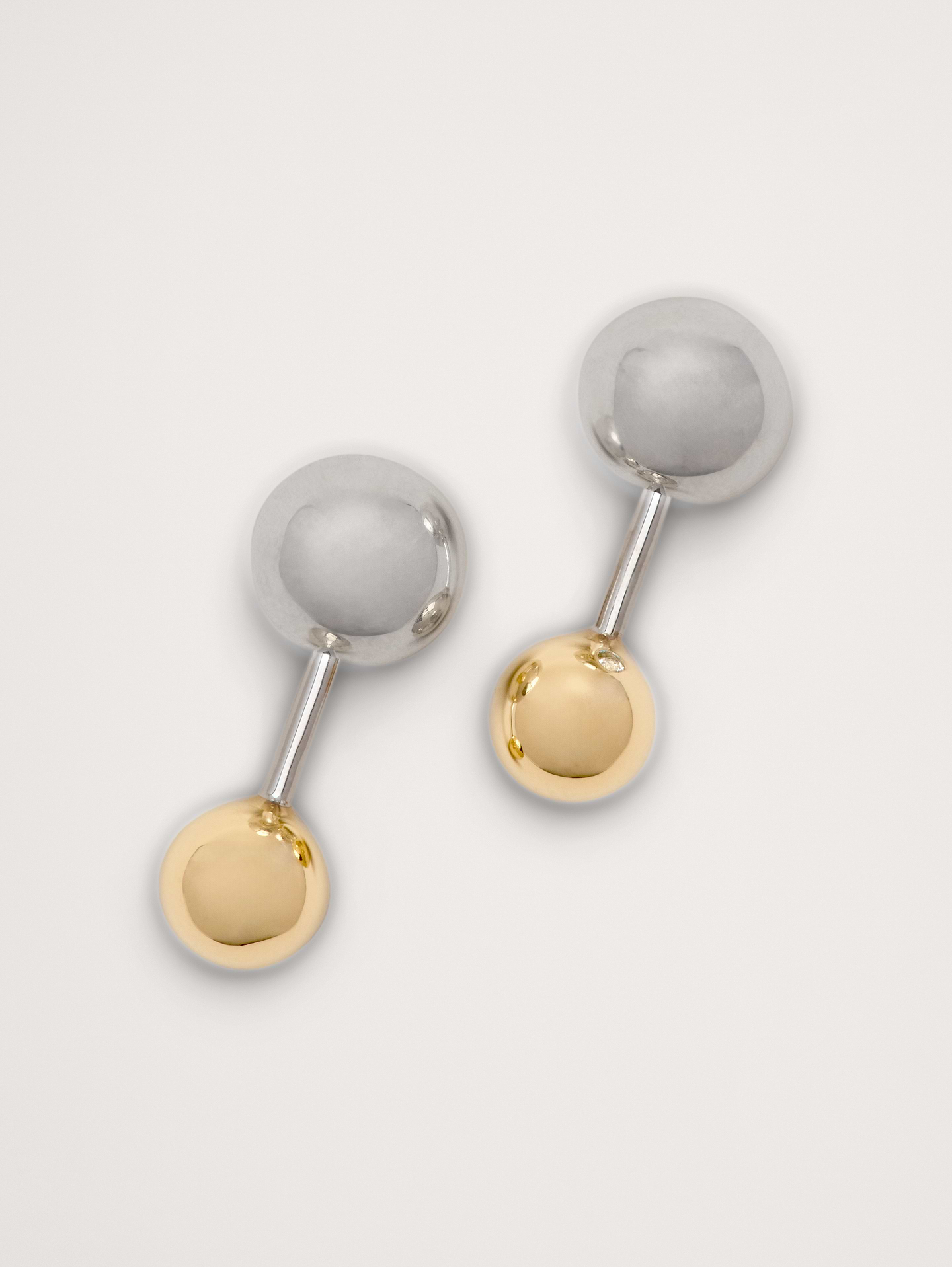 Image 1 of 3, Balanced barbell earrings with contrasting ball accents, in 14-karat gold and 999-silver plated brass. Can we worn with either color facing forward or back., 14k-gold and 999-silver plated brass., Post backs., Product #826436
